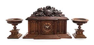 A Black Forest Style Carved Wood Clock Garniture Height overall 15 inches.