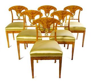 * A Set of Six Biedermeier Parcel Gilt Satinwood Side Chairs Height 26 inches.