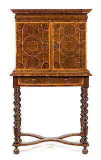 A William & Mary Oysterwood Cabinet on Stand Height 54 1/2 x width 29 1/2 x depth 18 1/4 inches.