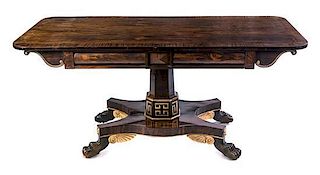 * A Regency Parcel Gilt Rosewood Center Table Height 30 x width 65 x depth 28 inches.