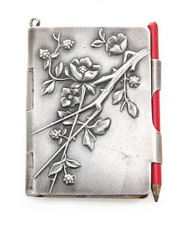 A Continental Silver Chatelaine Notepad, , the case worked to show flowering branches and opening to a partial sheet of stamp-cu