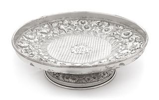 An American Silver Cake Stand, F. Bucher & Sons, Baltimore, MD, having allover floral and foliate repousse decoration and center