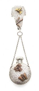 An American Silver and Mixed Metal Perfume Bottle, Dominick & Haff, New York, NY,, the bottle suspended from a chain to a centra