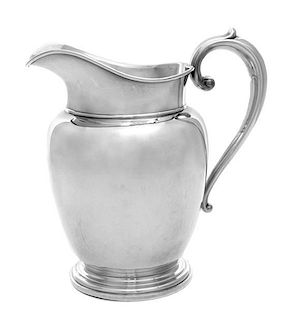 * An American Silver Water Pitcher, Manchester Silver Company, Providence, RI, having a baluster form body with a C-scroll handl