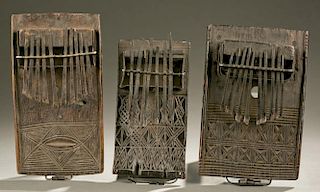 2 thumb pianos with carved linear motifs.