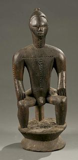 Bete seated male figure, 20th century.