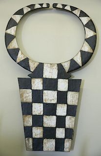 Horned plank mask with checkerboard design.