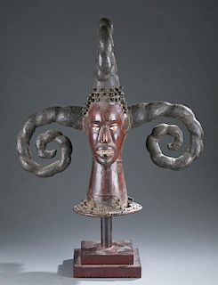 Skin covered headdress with curled horns