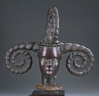 Skin covered headdress with five curled horns