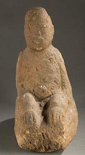 Seated stone figure.