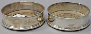 Pair of English silver wine coasters with wood bases. dia. 5in.