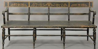 Windsor bench with plain back over large plank seat, set on turned legs, in old paint and stenciling, circa 1840. ht. 34in., wd. 76in.