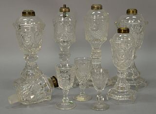 Eleven piece flint glass lot with seven whale oil lamps including two pairs, four stems, and three small lamps. ht. 4 1/2in. to 10 1...