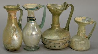 Four Roman thin glass jugs/pitchers with handles and applied ribbon design. ht. 2 1/2in. to 3 3/4in.