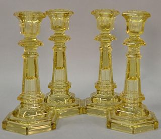 Set of four sandwich glass candlesticks, amber color, six sided. ht. 10in.