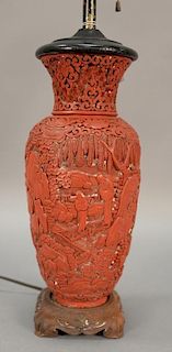 Chinese cinnabar vase with landscape design, made into a table lamp, on a carved hardwood stand. lamp ht. 12in.