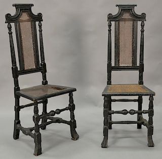 Pair of William and Mary side chairs having carved and caned backs and caned seats set on block and turned legs and stretchers endin...