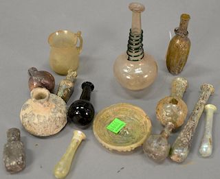 Fourteen small Roman glass pieces to include four medicine vials, four candlestick flasks, small dish, small encrusted flask, handle...