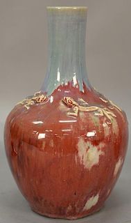 Chinese flambe glazed porcelain bottle vase, red flambe body with blue neck having molded dragons around base of the neck. ht. 14in.