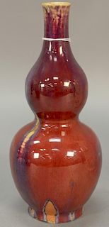 Chinese flambe glazed porcelain double gourd vase, oxblood red suffused with purple and light blue streaks. ht. 10in.