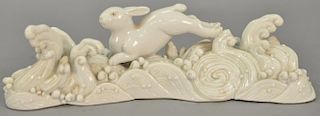 Chinese Blanc-de-chine porcelain brush rest with crashing waves and running rabbit, 18th/19th century. ht. 2in., lg. 7 3/4in. Proven...