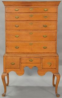 Queen Anne highboy in two parts, upper section with cornice molding over five drawers on lower portion with three short drawers with...