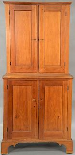 Primitive stepback cupboard in two parts with two doors in upper section over base with two doors, all set on bracket base. ht. 80in...