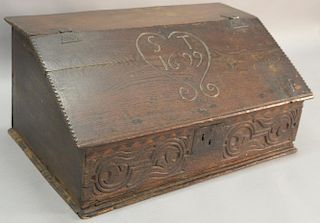 Oak bible box having slant hinged lid with chip carved edges over carved front with three drawer interior, lid carved with "S.T. 169...