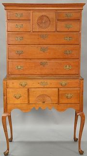 Queen Anne cherry highboy in two parts, upper portion with large cornice molding over pinwheel center drawer flanked by dual short d...