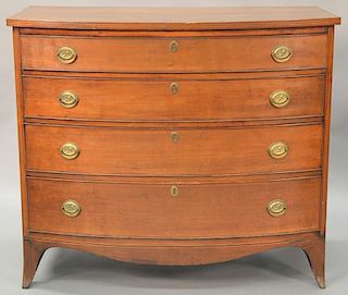 Federal cherry bowed front chest having four drawers set on French feet, circa 1790. ht. 34 3/4in., case wd. 39 1/4in.