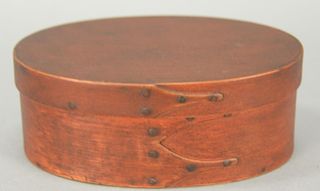 Shaker oval covered three finger box in old red paint. ht. 2 3/8in., top: 4" x 6"