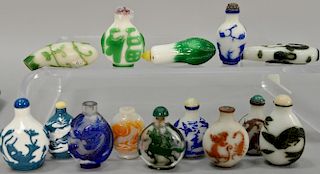 Fourteen overlay glass snuff bottles depicting deer, dragons, phoenix birds, goats, cranes, etc.  ht. 2 1/4in. to 3in.