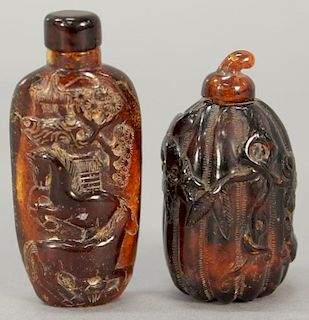 Two large amber snuff bottles including one depicting horses with pine trees and the other in the form of a gourd.  ht. 2 1/2in. t...