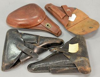 Group of four holsters including two German WWII leather pistol PPK holsters, a tan leather German, and a WWII Japanese clamshell le...