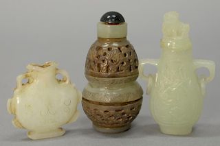 Three carved white and celadon jade snuff bottles, one carved reticulated with double bands.  ht. 3/4in. to 3in.