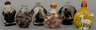 Six overlay glass snuff bottles including five dark amber with butterfly, cranes, and a goat, one three color overlay having snowfla...