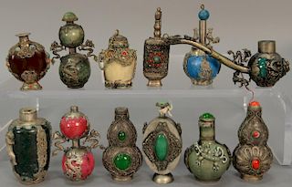 Twelve silver and jeweled mounted snuff bottles to include six silver mounted dragon hardstone bottles, six snuff bottles mounted wi...