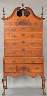 Chippendale cherry high chest in two parts, upper section with full bonnet top on lower section with carved skirt set on cabriole le...