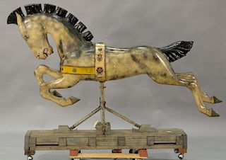 Horse carousel figure now on block stand with springs, early to mid 20th century.  total ht. 59in., lg. 84in.
