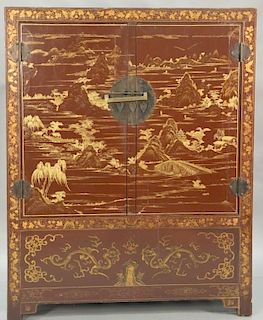 Chinese lacquered wardrobe cabinet with two doors, chinoiserie decorated interior with shelves and drawers. ht. 71 1/2in., wd. 56 1/...
