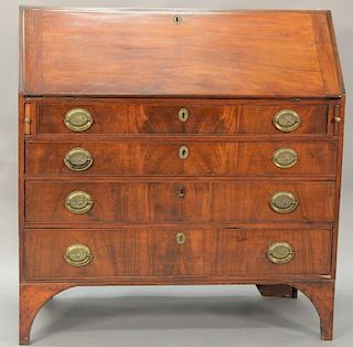 Federal mahogany desk having slant lid over four drawers set on bracket feet, circa 1790. ht. 43in., wd. 42in.