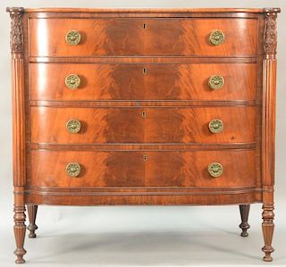 Sheraton mahogany bowfront chest with cookie corners having carved and fluted columns on turned and fluted legs, probably North Shor...