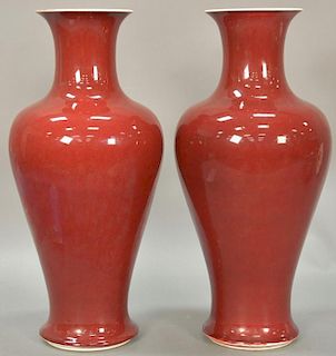 Pair of Chinese Sang de Boeuf porcelain vases in baluster form with flared white top rim, marked