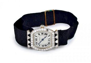 An Art Deco Platinum Diamond Onyx Watch, by Cartier