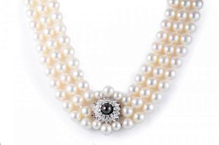 A Three Strand Cultured Pearl and Diamond Necklace