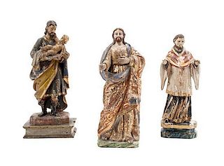 Three Carved Wood Santos Figures Height of tallest 12 inches.