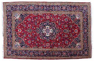 A Tabriz Wool Rug 9 feet 11 inches x 6 feet 7 1/2 inches.