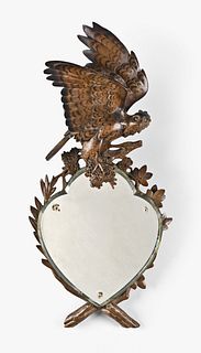 A good 20th century Black Forest carved wall mirror