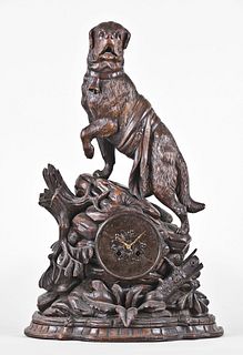 A good turn of the 20th century carved figural Black Forest clock with St. Bernard