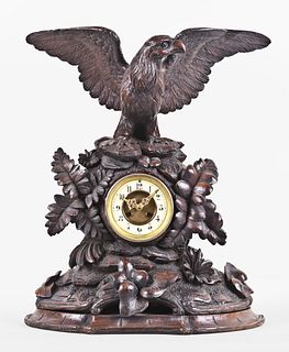 A good turn of the 20th century carved figural Black Forest clock with eagle